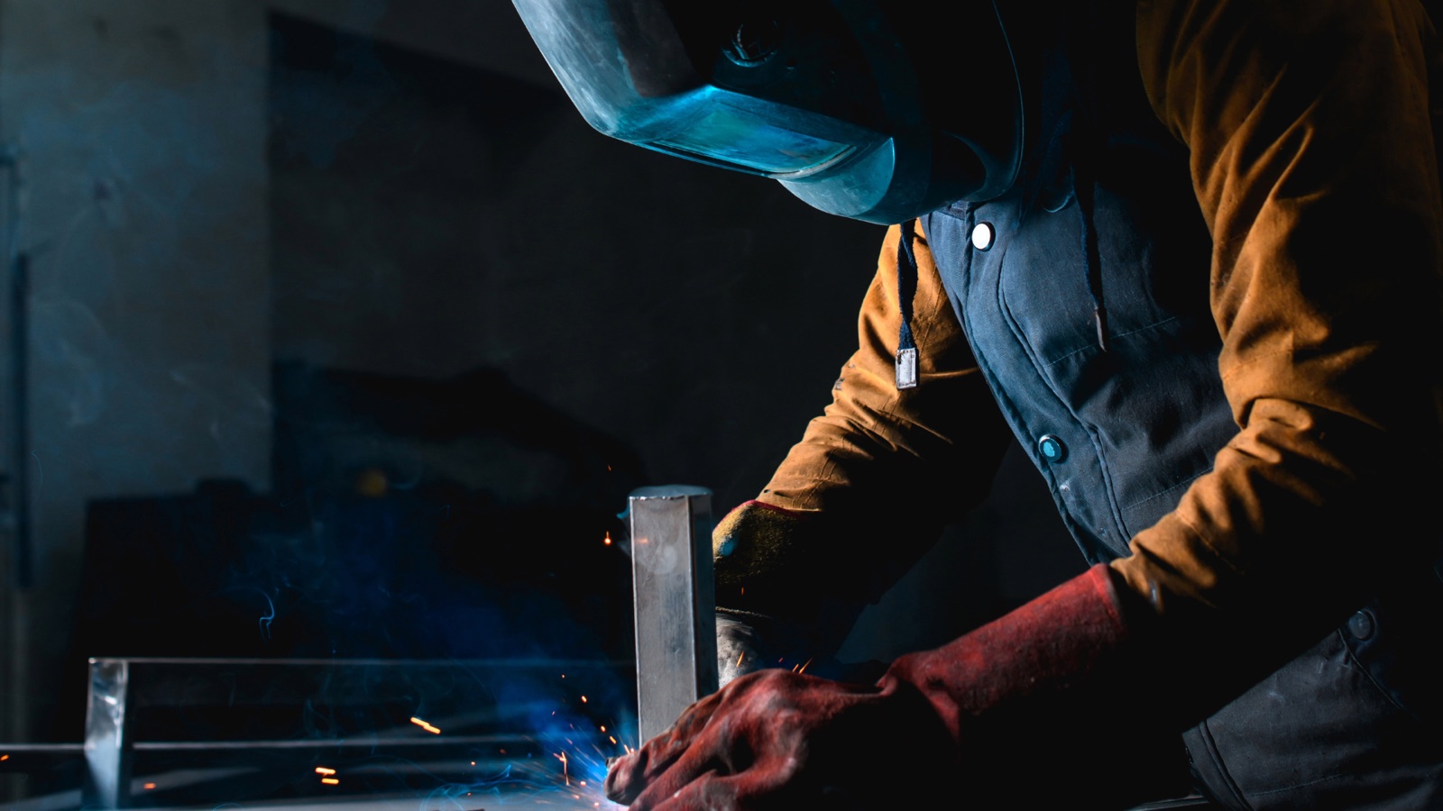 A welder working in a fabrication shop