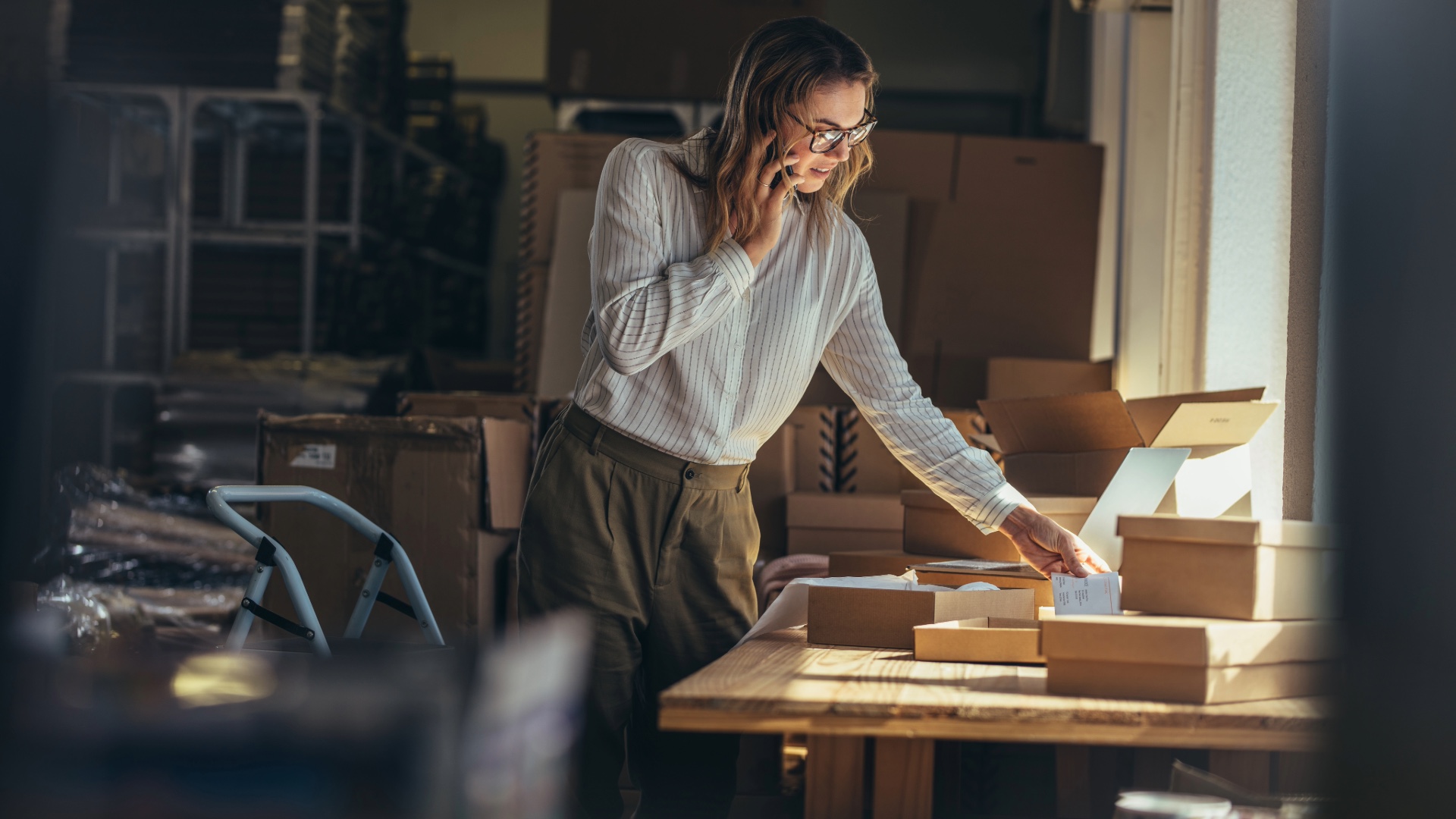 A small-business owner managing orders by phone