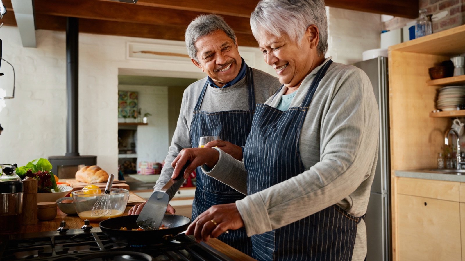 Retired couple cooking together at home