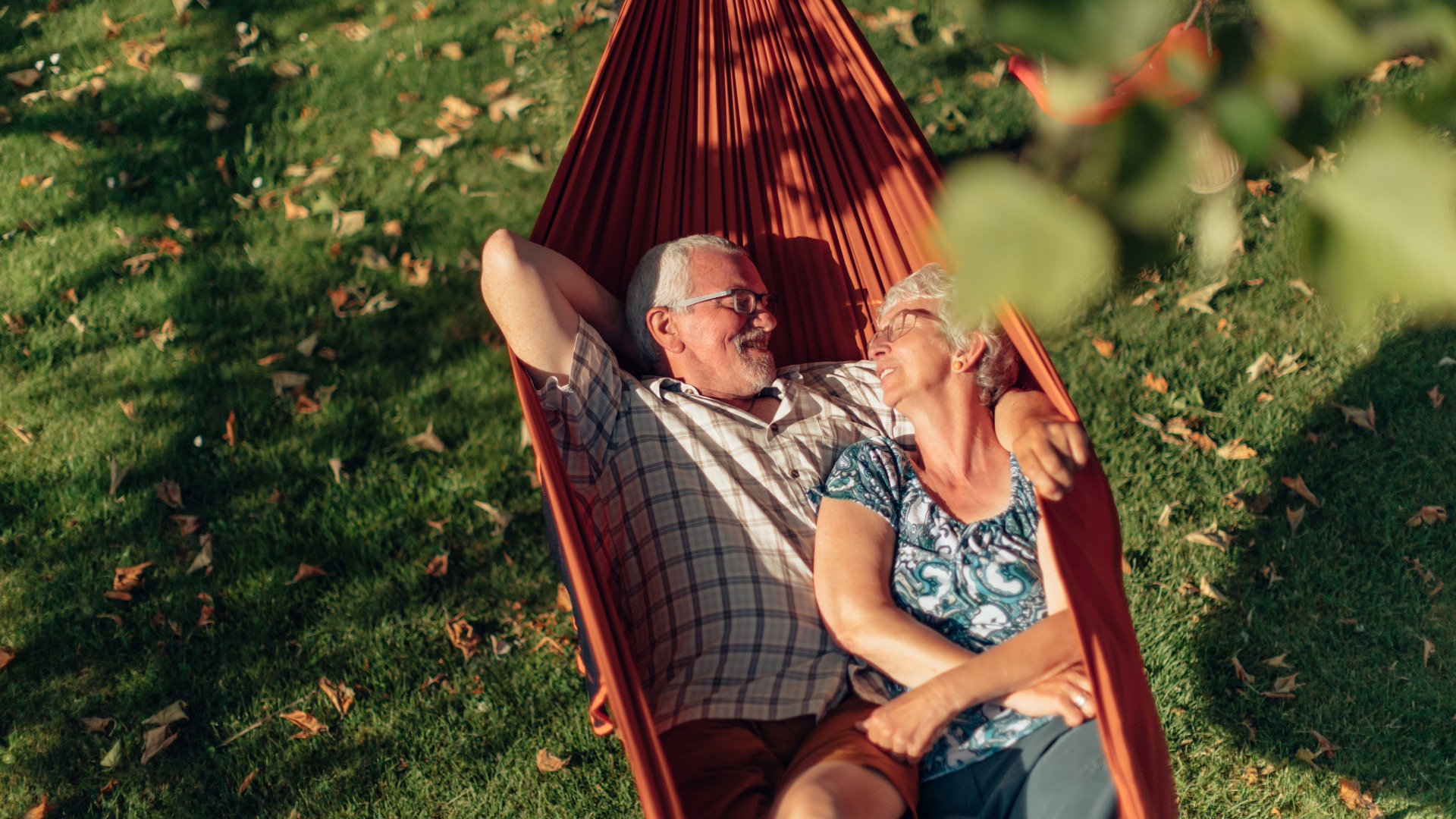 Retired couple relaxing together in a hammock