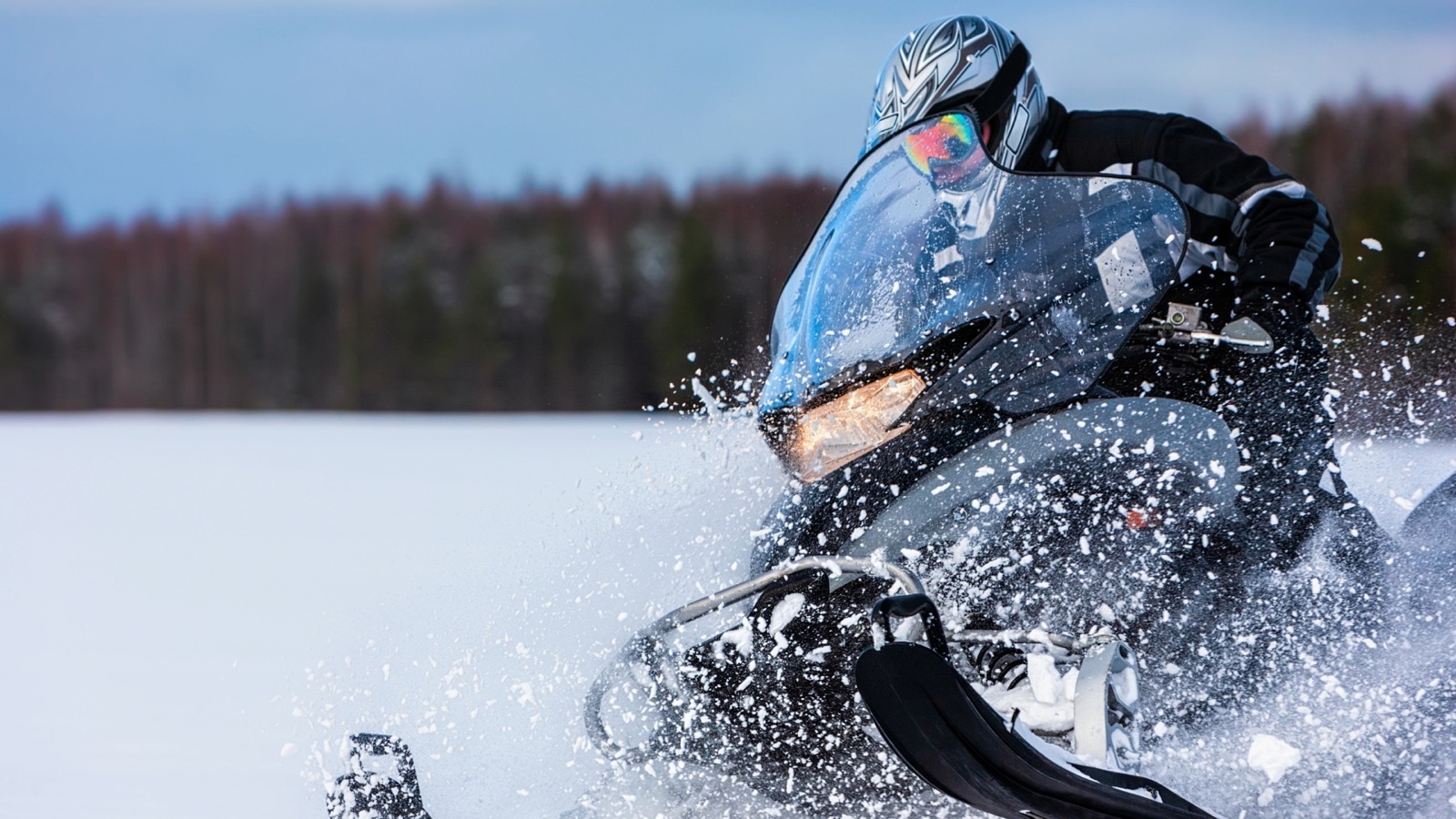 A snowmobiler carving through fresh powder
